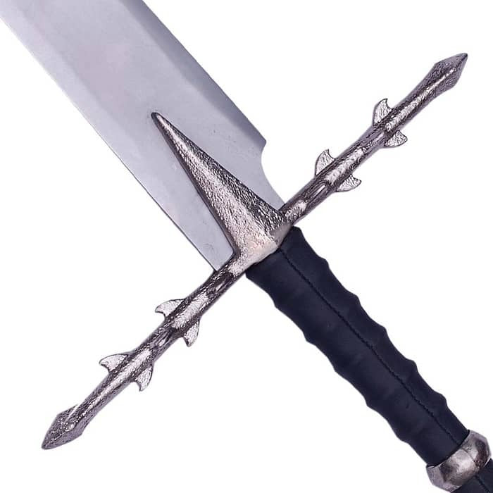 A close-up of a fantasy sword with a textured silver blade, a decorative silver crossguard, and a black wrapped handle on a white background.