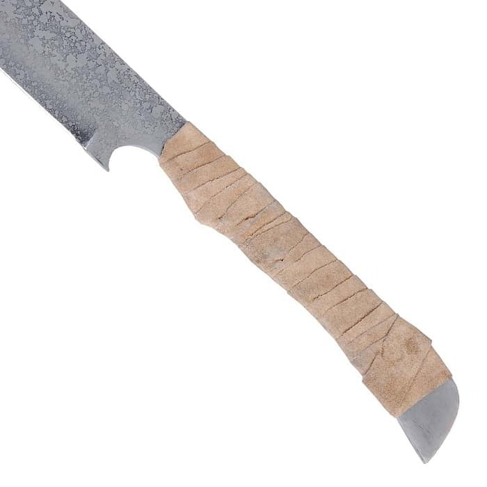 A close-up of a knife with a textured gray steel blade and a light tan leather-wrapped handle, shown against a plain white background.