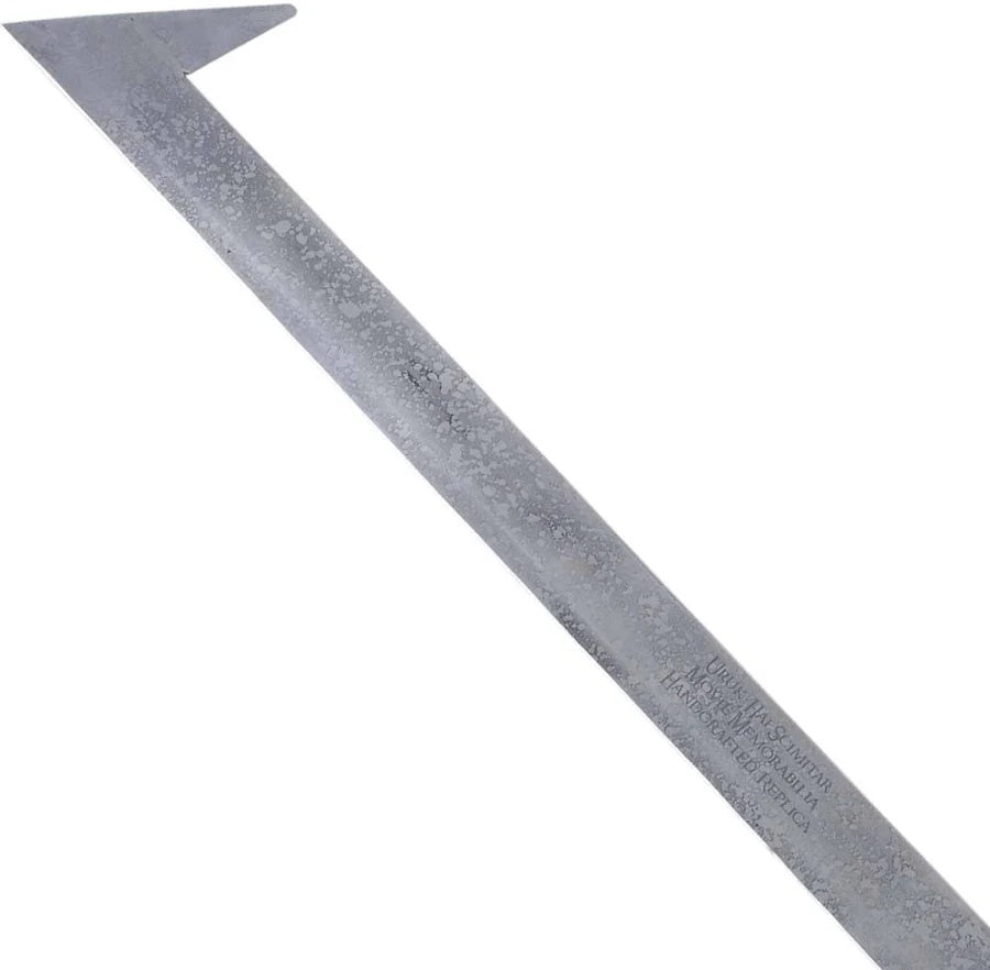 A long, narrow metal tool with a wide triangular end and a textured silver-gray finish, photographed diagonally on a plain white background.